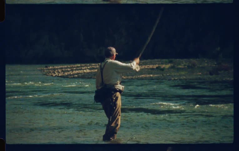 Man in cap fishing in a river