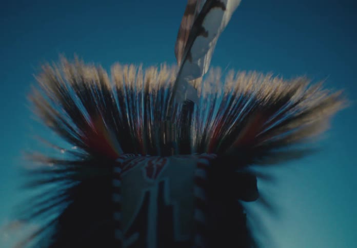 Head of a person in a native american feather costume