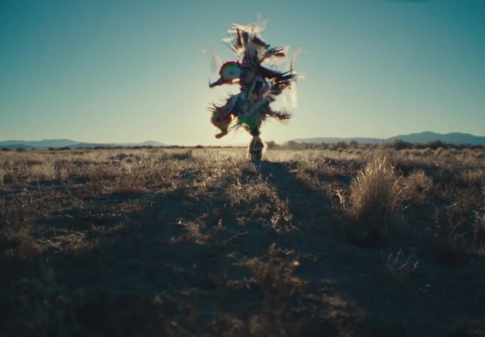 Person dancing in a field while wearing a costume