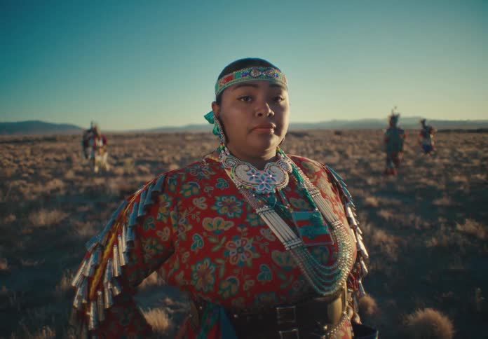 Native american woman member of a tribe wearing traditional ceremonial attire