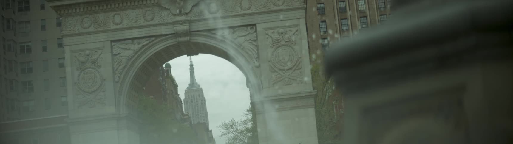 Water flies through the air with city buildings in the background