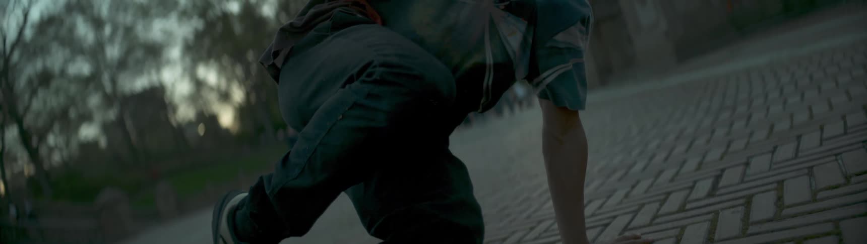 A person dancing in a city park and it is close up