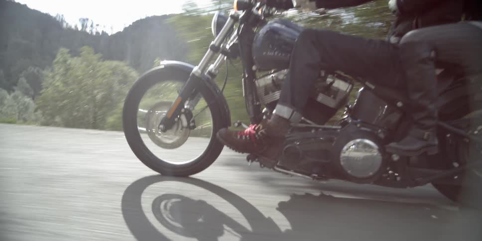 A man and woman ride on a motorcycle