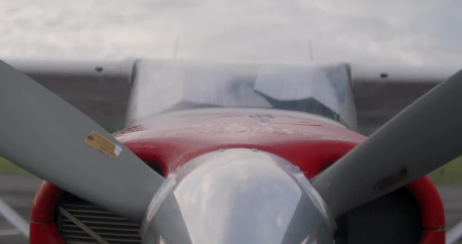 The front of a small plane with the propellers stopped