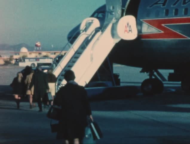Group of people walking towards a plane on the runway