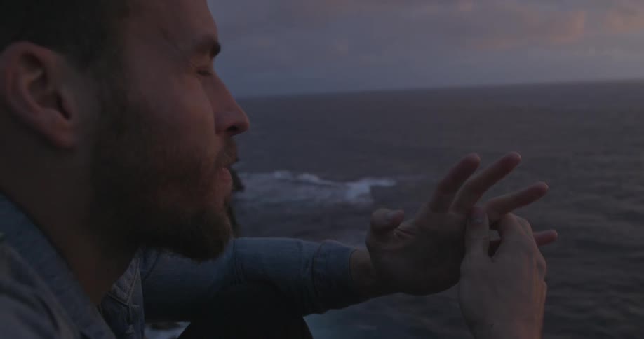 A man looks out towards the ocean