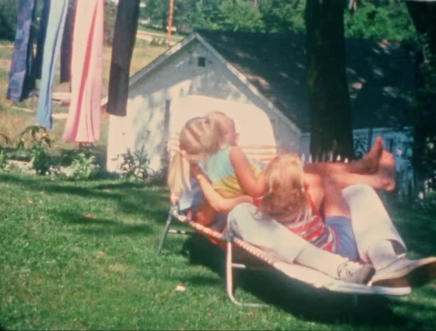 A clip of a father playing with his daughters outdoor