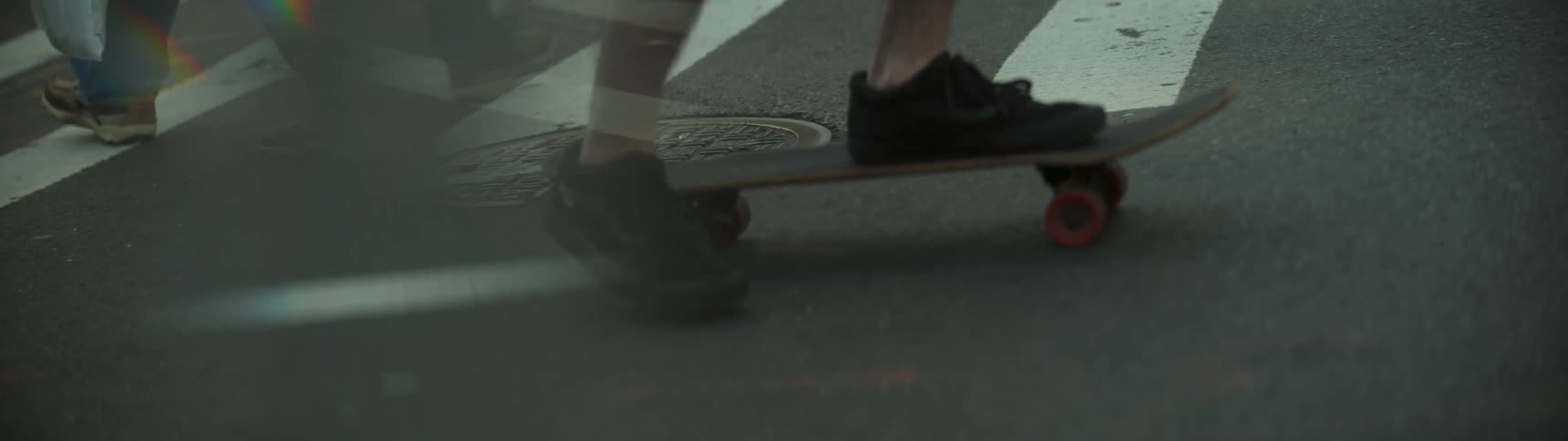 A person rides their skateboard on the street