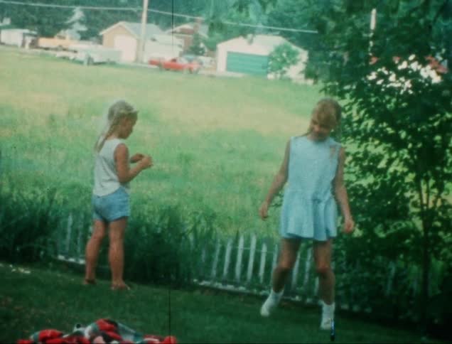 Two girls playing in a garden
