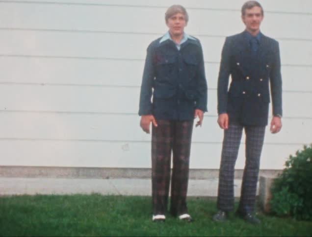 Man and a teenager side by side wearing formal clothing