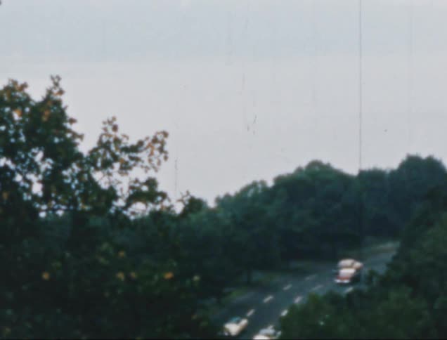 Several cars round the bend on a road