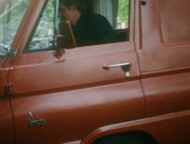 Person getting into a classic red van