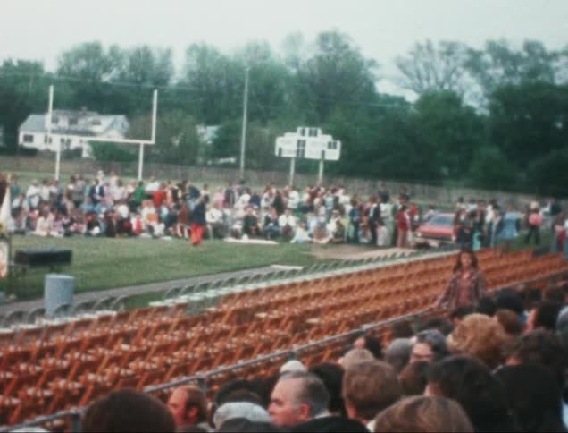 Crowd of people sitting in a grandstand at an event