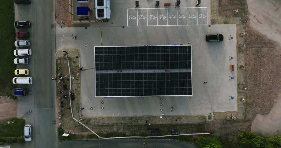 Aerial view of a building with solar panels and people walking around