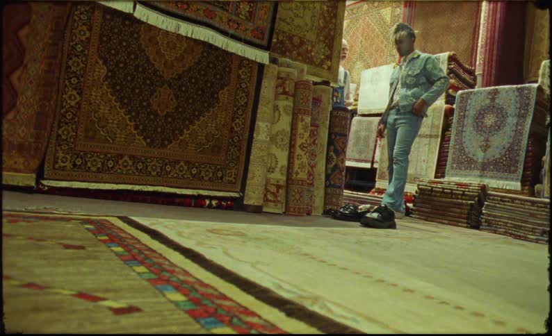 Man in denim look in a store with carpets