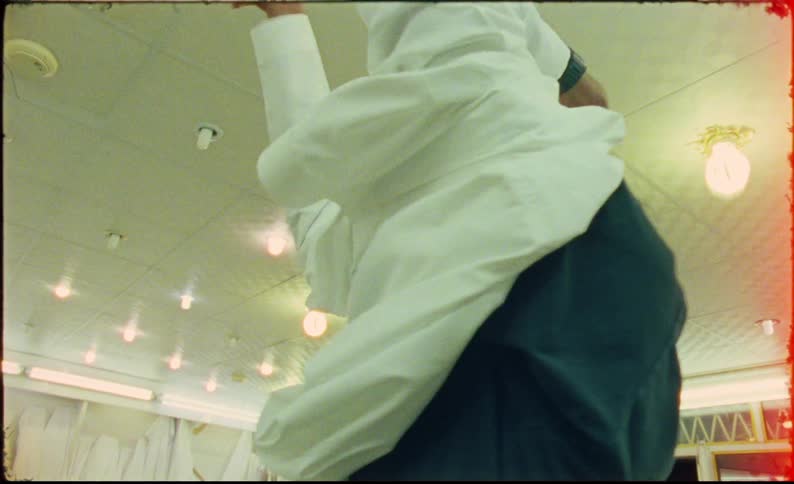 Man trying on a white robe in a store
