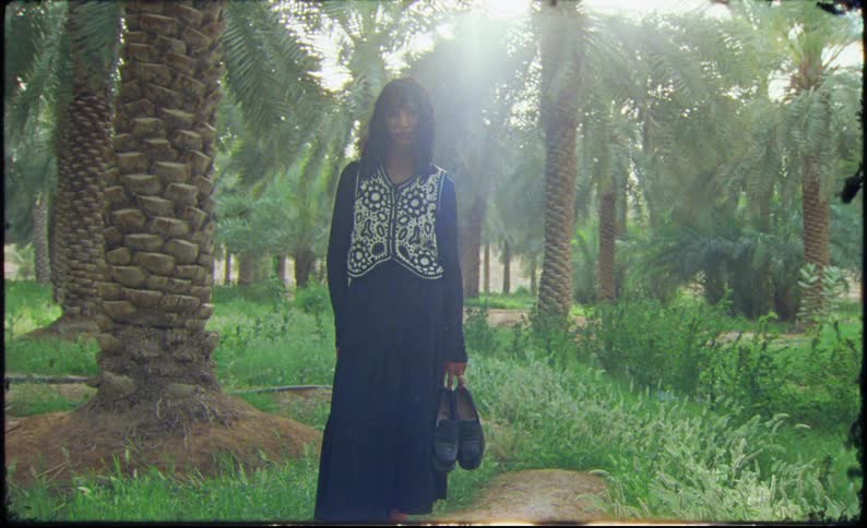 A clip of a female model out in the palm plantation