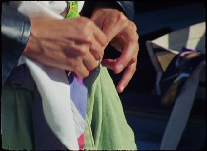 A woman adjusts her clothing outside