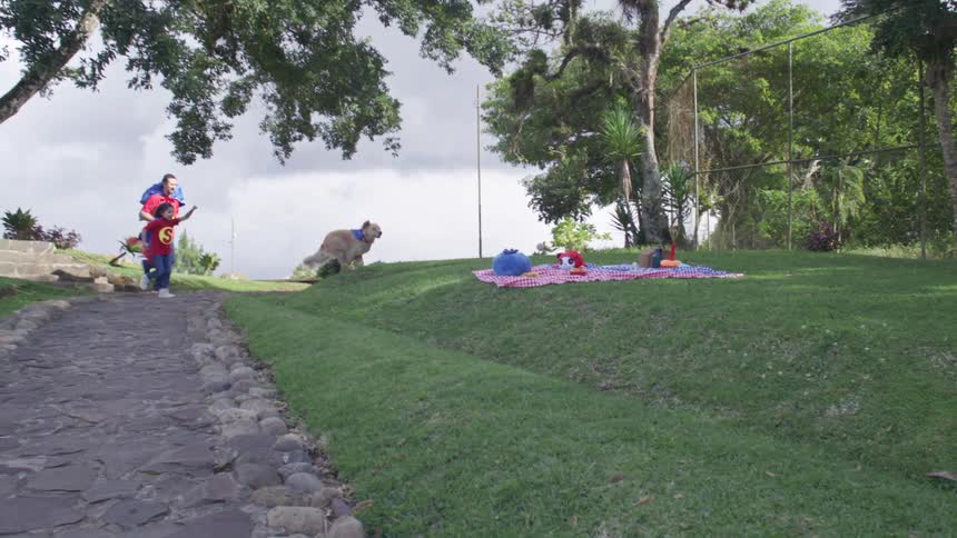 Father and daughter playing as superheroes in the park