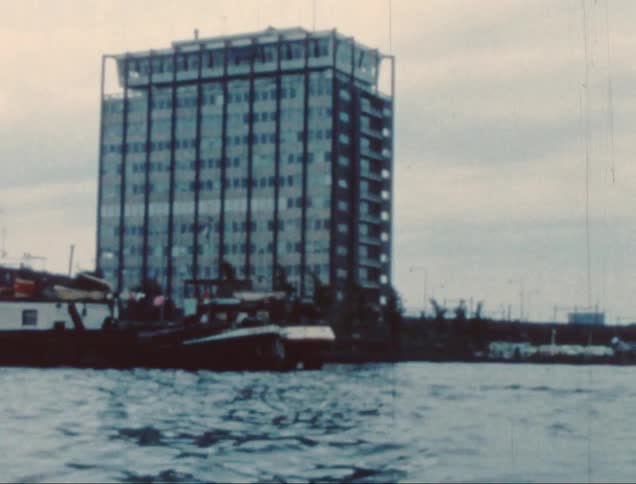Building under construction near boats in the water