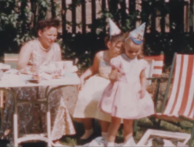 Two children and a woman at a birthday party