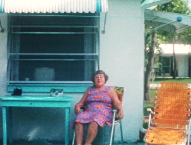 A footage of an elderly couple seated outdoor