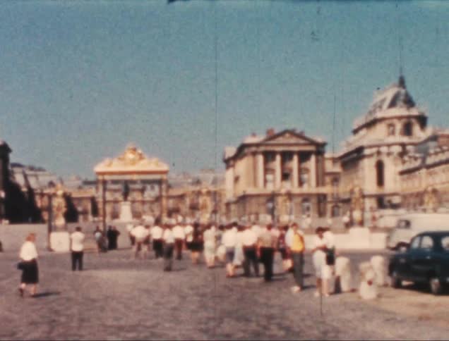 A crowd of people walk on a city street
