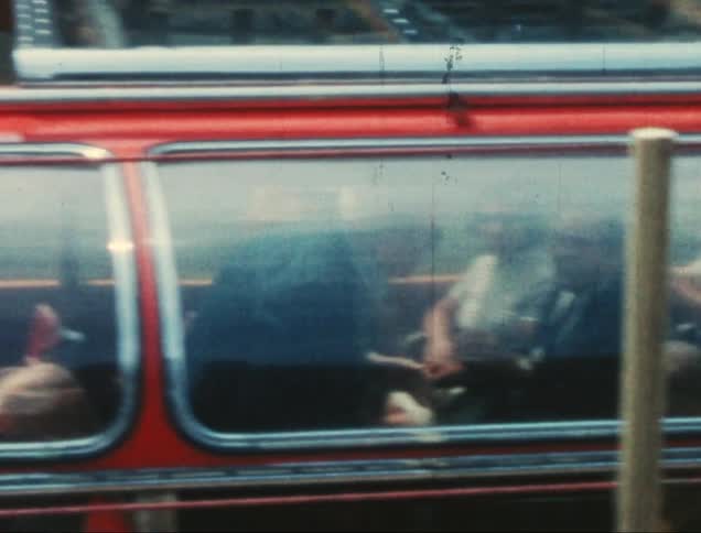 A camera pans across a boat filled with people