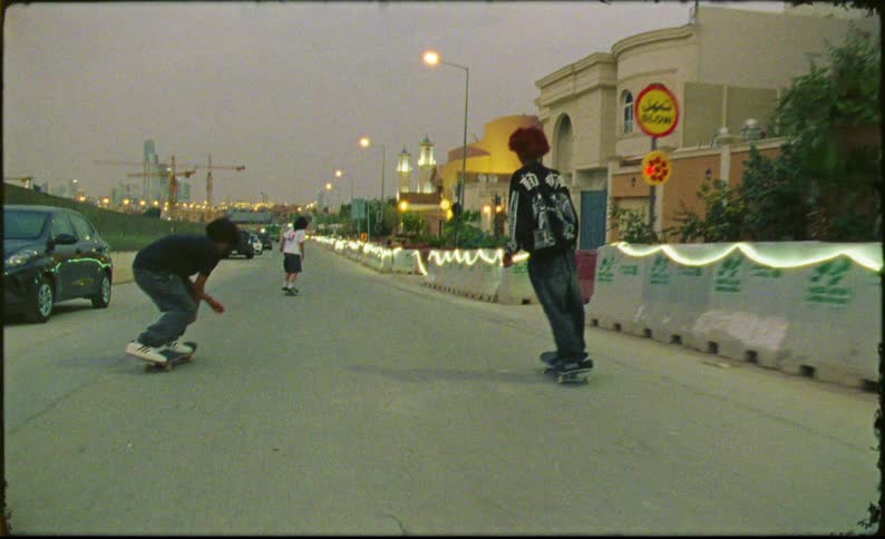Teenagers on a street skateboarding