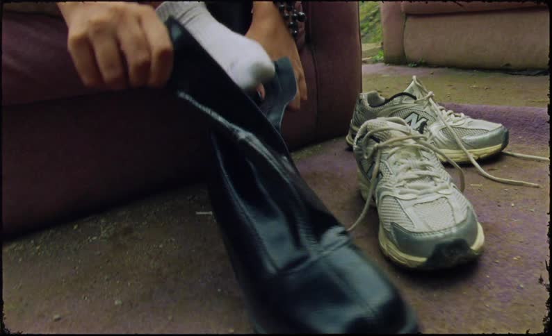 A woman puts on a pier of boots