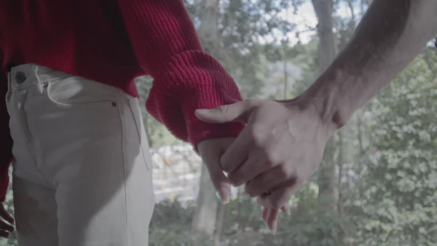 Man and woman holding hands together