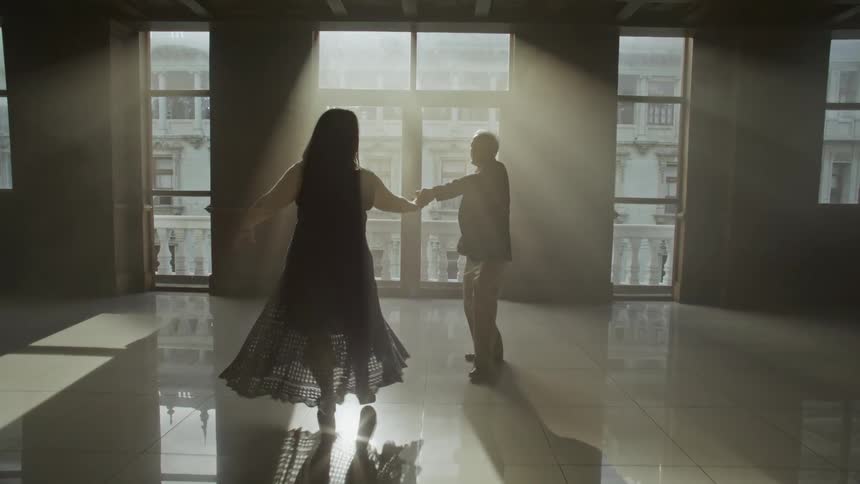 Man and woman dancing classically in a ballroom
