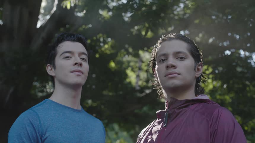 Portrait of two young men under a tree