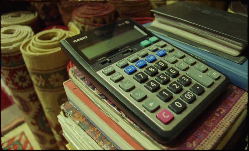 Calculator on top of books in a carpet store