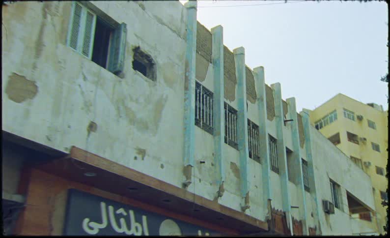 Walking along past a long white stone building