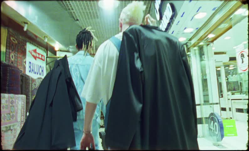 A clip oftwo males walking the corridor