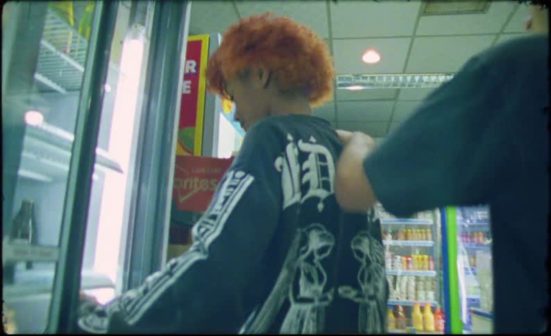 Teenagers with skateboards in their hands walking down the aisle of a supermarket