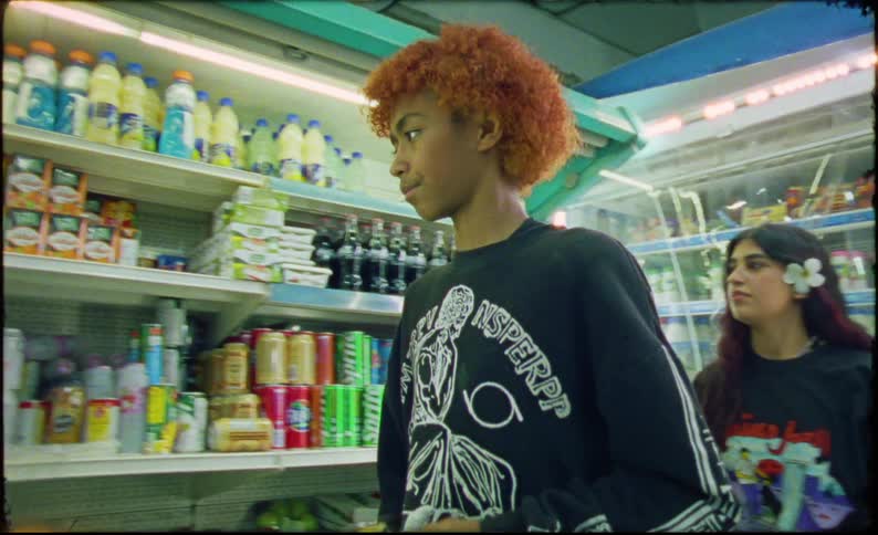 Teenagers buying drinks from a convenience store