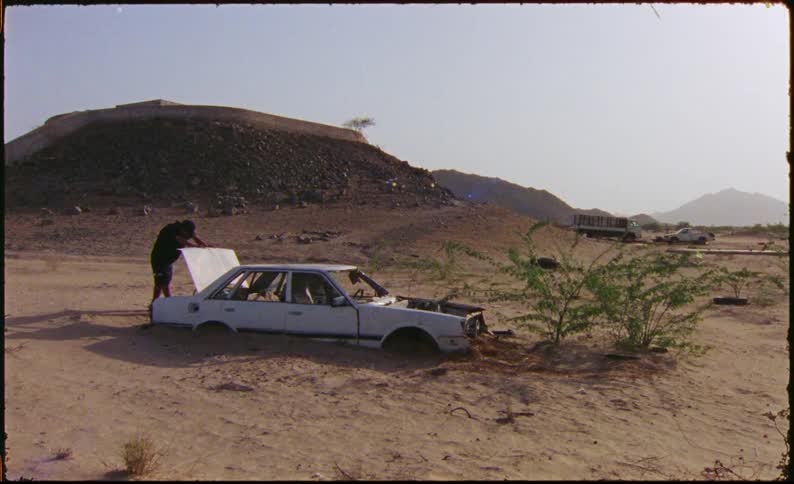 A clip of a car steeved in the sand