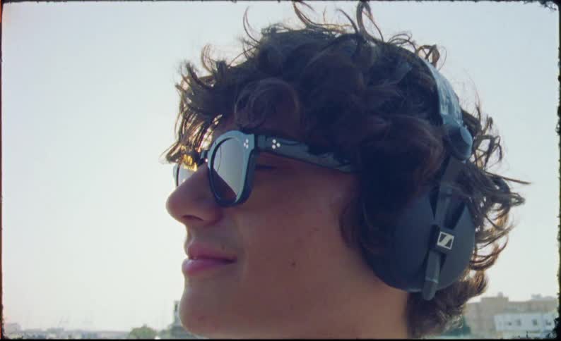 An head clip of a teenager putting on a headset