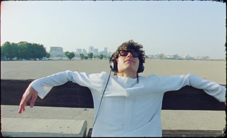 A close up clip of a male listening to music