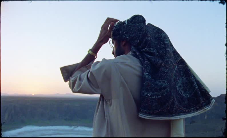 Man with a scarf on his head in an outdoor natural area