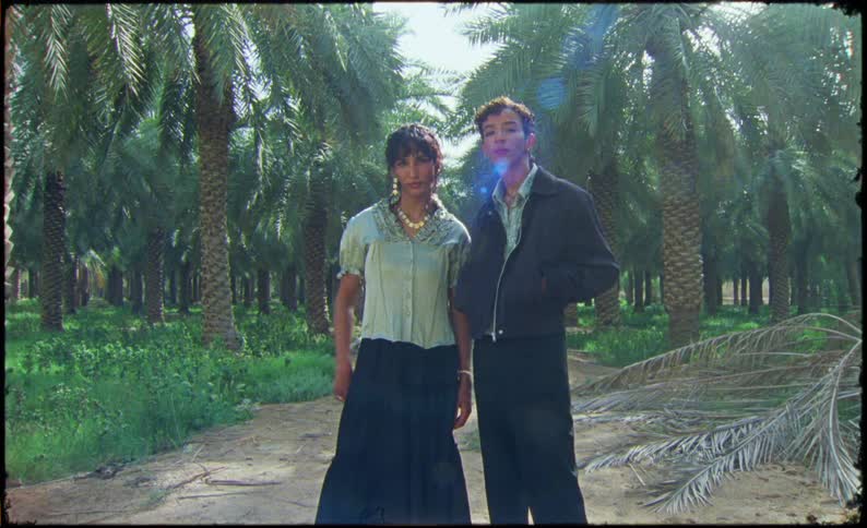 Man and woman models on a trail in a tropical forest