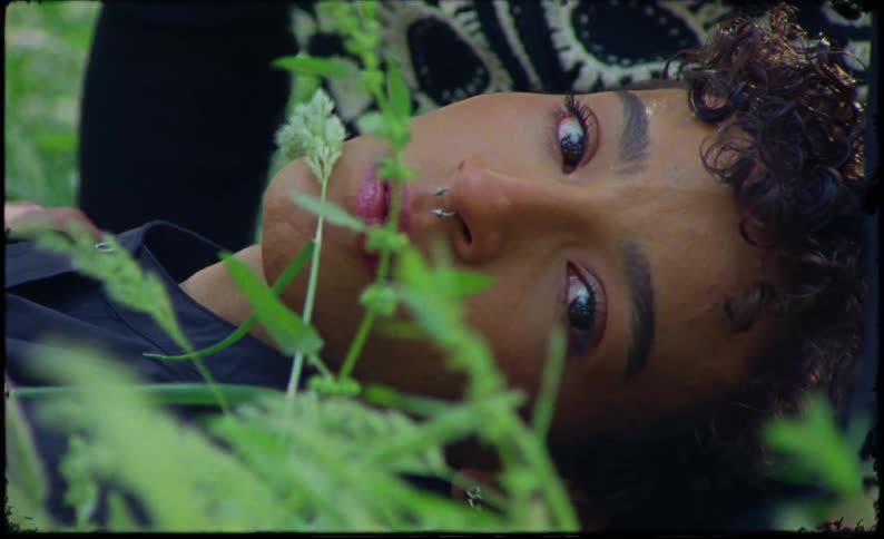 Portrait of a woman lying on the grass