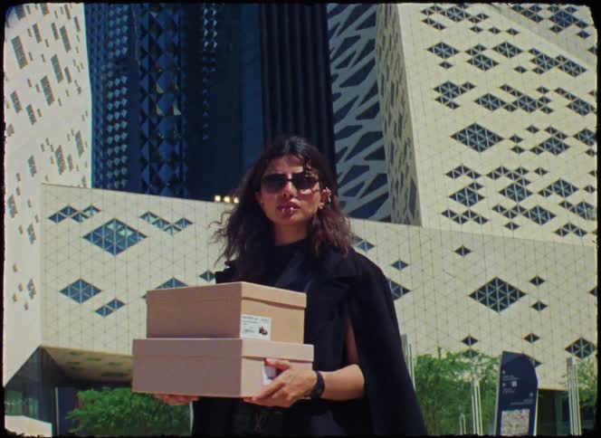 Woman holding two shoe boxes