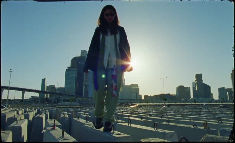 A clip of a teenager walking on concrete