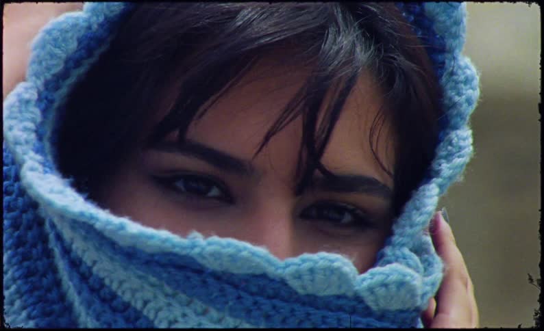 Portrait of a woman with a blue scarf on her head