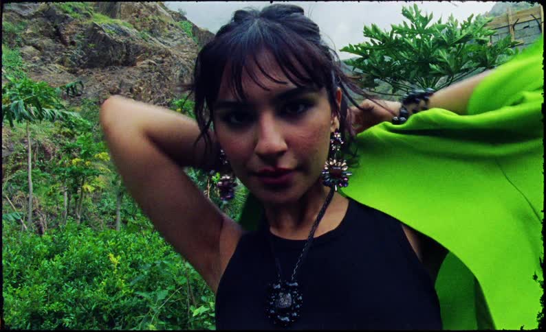 Woman putting on a green blazer