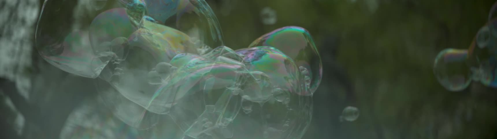 Bubbles float together in the air popping