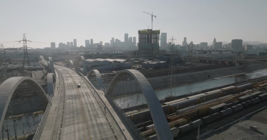 Aerial view of a bridge with skyscrapers in the background